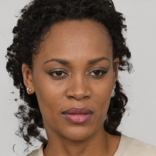 Neutral black adult female with medium  brown hair and brown eyes