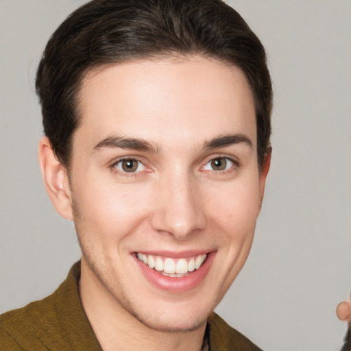 Joyful white young-adult male with short  brown hair and grey eyes