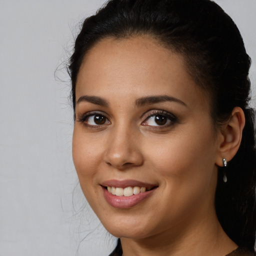 Joyful white young-adult female with long  brown hair and brown eyes