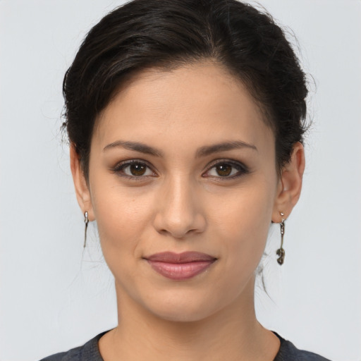 Joyful latino young-adult female with medium  brown hair and brown eyes
