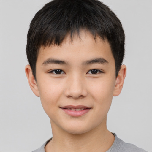 Joyful asian child male with short  brown hair and brown eyes