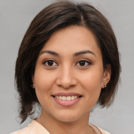 Joyful white young-adult female with medium  brown hair and brown eyes