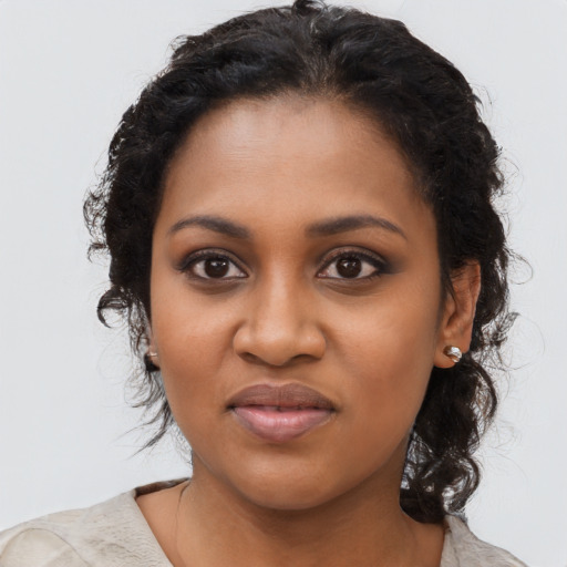 Joyful black young-adult female with medium  black hair and brown eyes