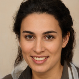 Joyful white young-adult female with medium  brown hair and brown eyes