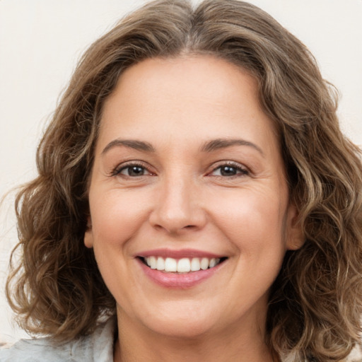 Joyful white young-adult female with medium  brown hair and green eyes