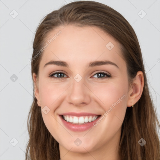 Joyful white young-adult female with long  brown hair and grey eyes