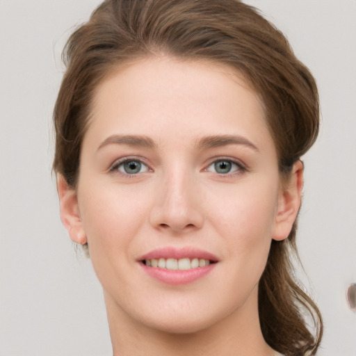 Joyful white young-adult female with medium  brown hair and grey eyes