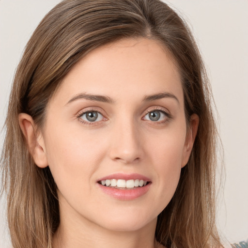 Joyful white young-adult female with long  brown hair and grey eyes