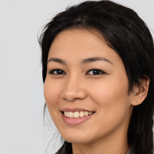 Joyful asian young-adult female with long  black hair and brown eyes