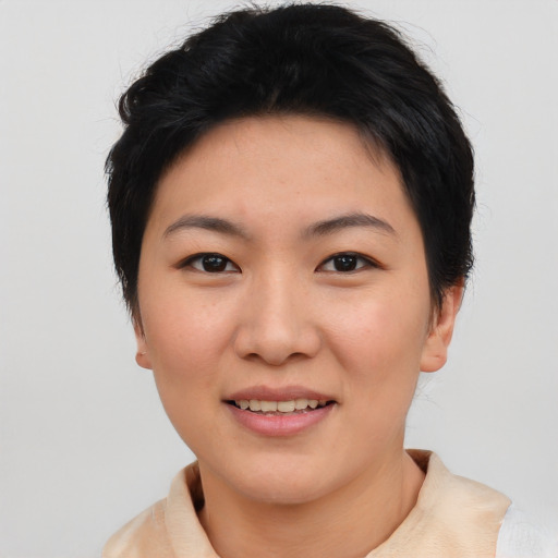 Joyful asian young-adult female with short  black hair and brown eyes