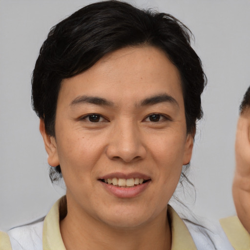 Joyful asian young-adult female with medium  brown hair and brown eyes