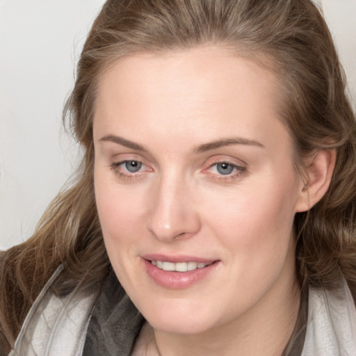 Joyful white young-adult female with medium  brown hair and blue eyes