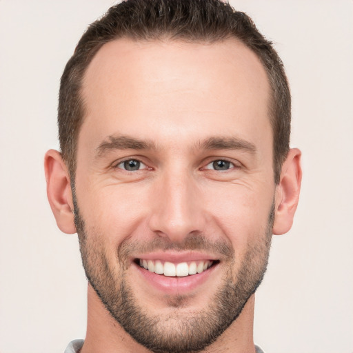 Joyful white young-adult male with short  brown hair and brown eyes