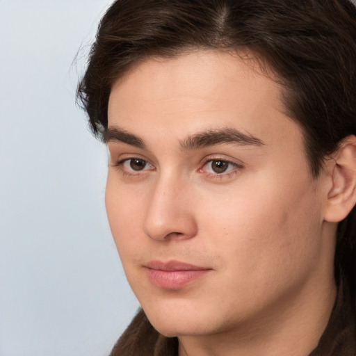 Neutral white young-adult male with long  brown hair and brown eyes