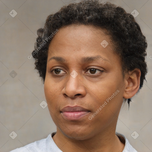 Joyful black adult female with short  brown hair and brown eyes