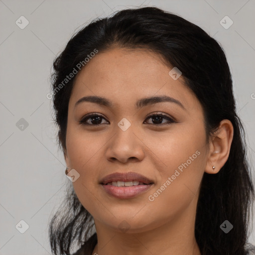 Joyful latino young-adult female with long  black hair and brown eyes