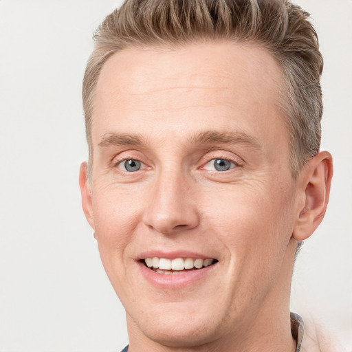 Joyful white adult male with short  brown hair and grey eyes