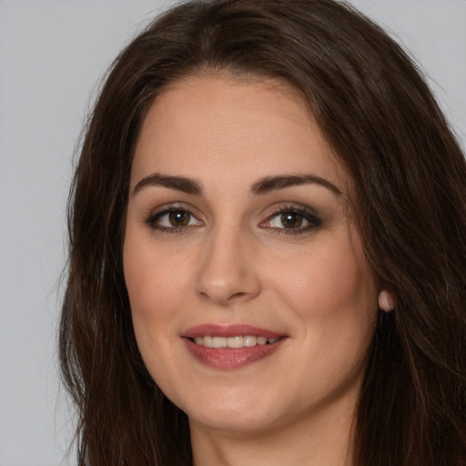 Joyful white young-adult female with long  brown hair and brown eyes