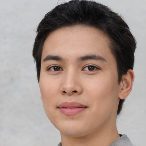 Joyful white young-adult male with short  black hair and brown eyes