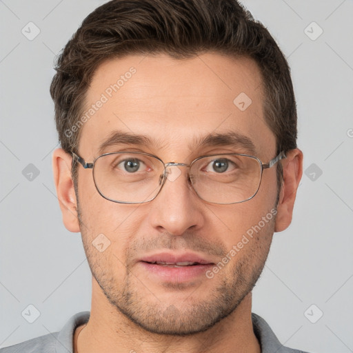 Joyful white adult male with short  brown hair and brown eyes