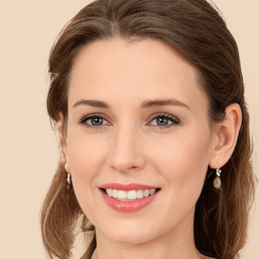 Joyful white young-adult female with long  brown hair and brown eyes