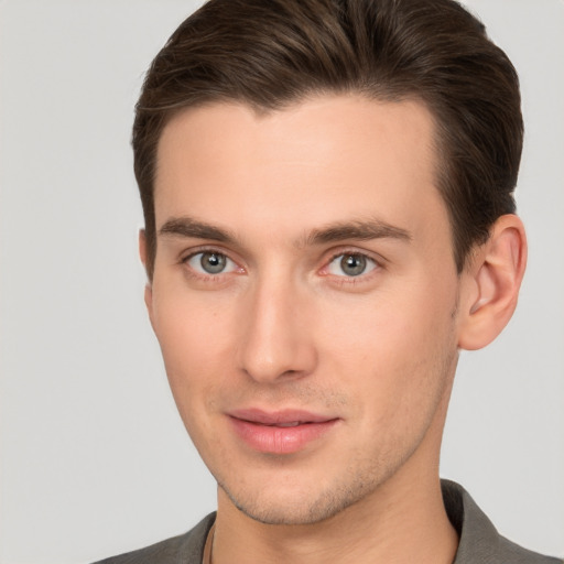 Joyful white young-adult male with short  brown hair and brown eyes