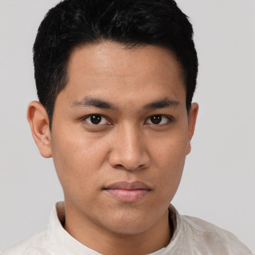 Joyful asian young-adult male with short  brown hair and brown eyes