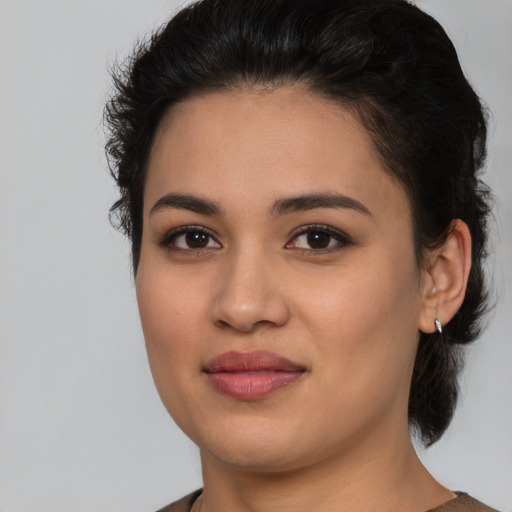 Joyful latino young-adult female with medium  brown hair and brown eyes