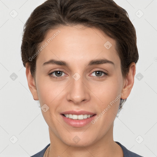 Joyful white young-adult female with short  brown hair and grey eyes