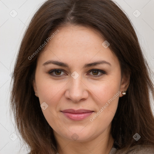 Joyful white adult female with long  brown hair and brown eyes