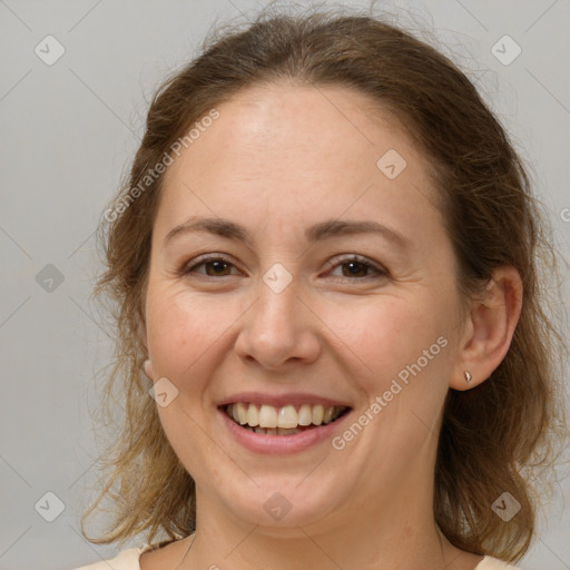 Joyful white adult female with medium  brown hair and brown eyes