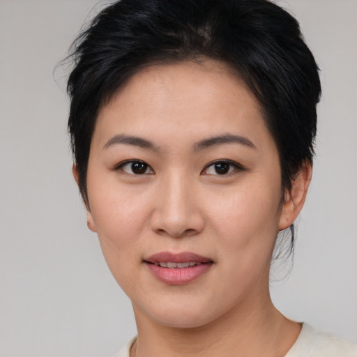 Joyful asian young-adult female with medium  brown hair and brown eyes