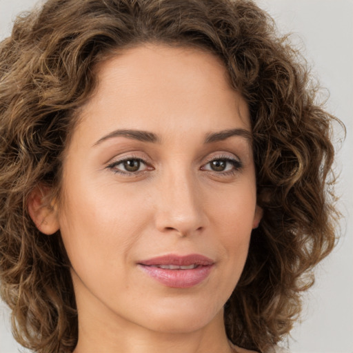 Joyful white young-adult female with long  brown hair and green eyes