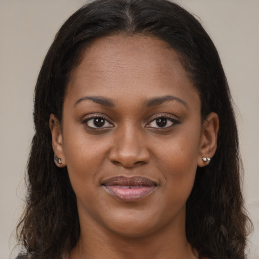 Joyful black young-adult female with long  brown hair and brown eyes