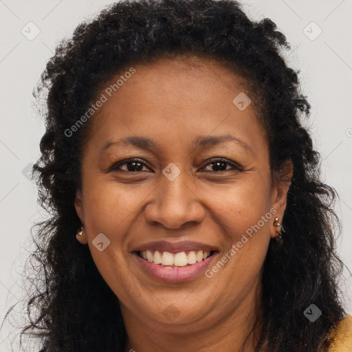 Joyful black adult female with long  brown hair and brown eyes