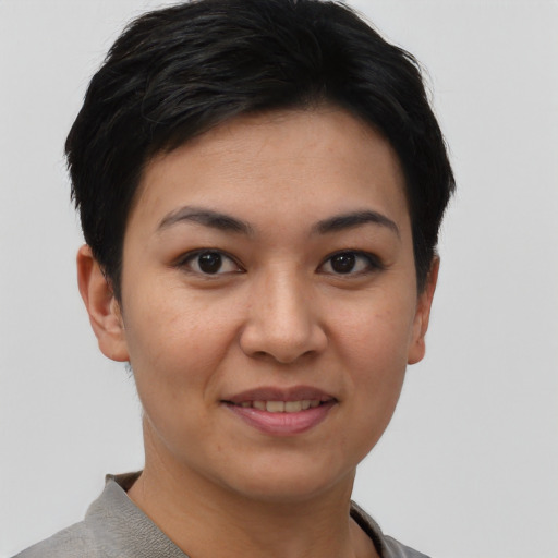 Joyful asian young-adult female with short  brown hair and brown eyes