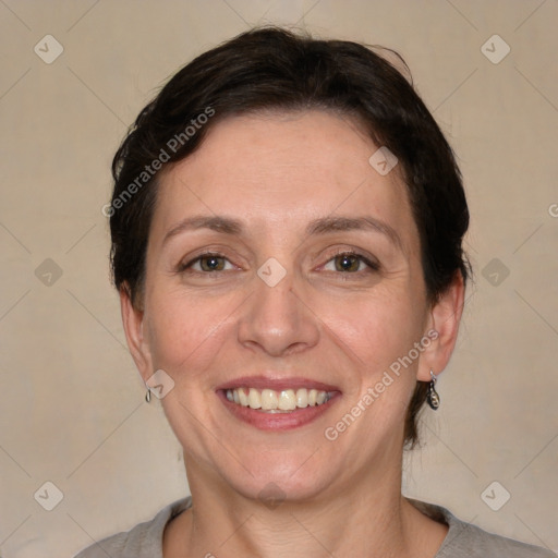 Joyful white adult female with medium  brown hair and grey eyes