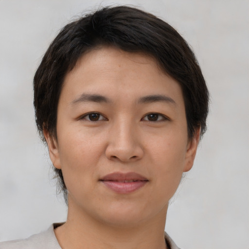 Joyful asian young-adult female with short  brown hair and brown eyes