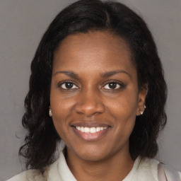 Joyful black young-adult female with medium  brown hair and brown eyes