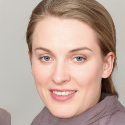 Joyful white young-adult female with medium  brown hair and blue eyes