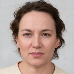 Joyful white young-adult female with medium  brown hair and green eyes