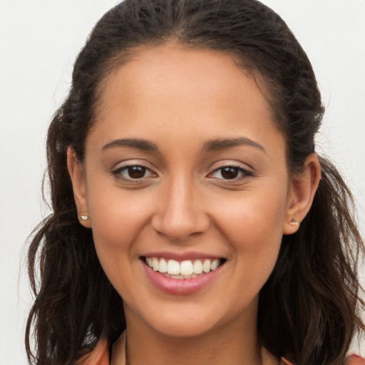 Joyful white young-adult female with long  brown hair and brown eyes