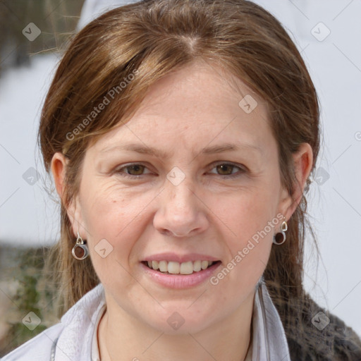 Joyful white adult female with medium  brown hair and blue eyes