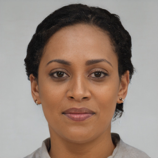 Joyful latino adult female with short  brown hair and brown eyes