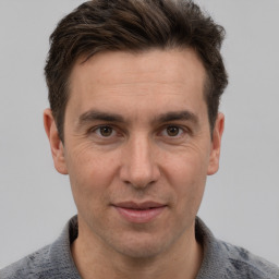 Joyful white adult male with short  brown hair and grey eyes