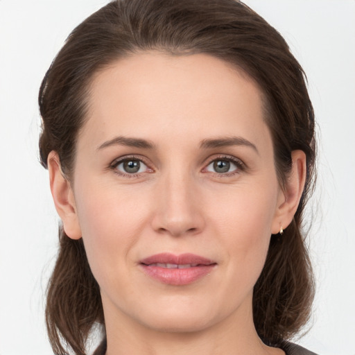 Joyful white young-adult female with medium  brown hair and grey eyes