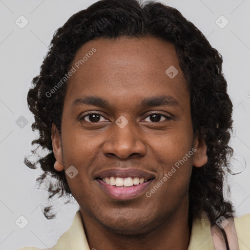 Joyful black young-adult male with short  brown hair and brown eyes