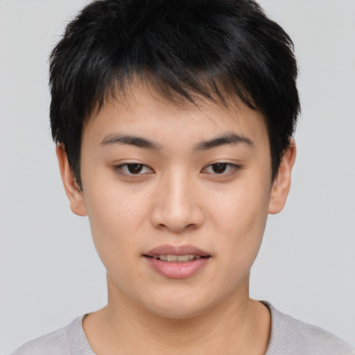 Joyful asian young-adult female with short  brown hair and brown eyes