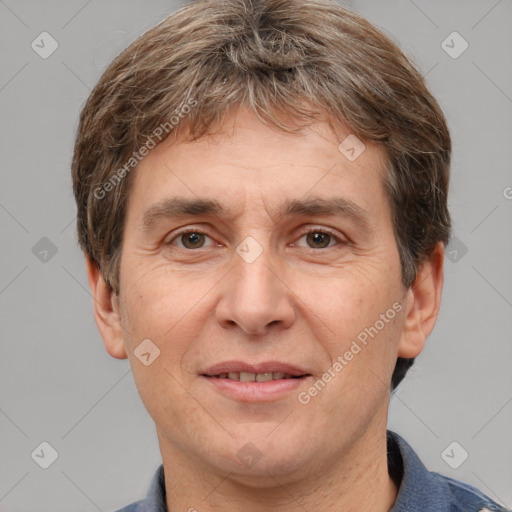 Joyful white adult male with short  brown hair and grey eyes