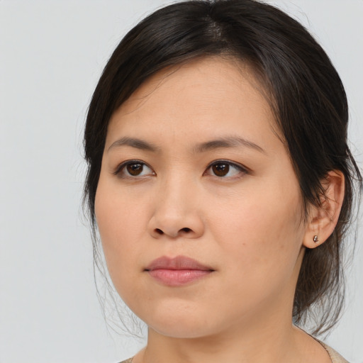 Joyful asian young-adult female with medium  brown hair and brown eyes